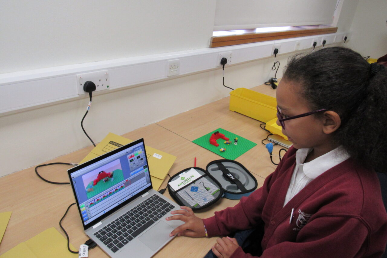 A young pupil works on a laptop in a Primary Project computing lesson