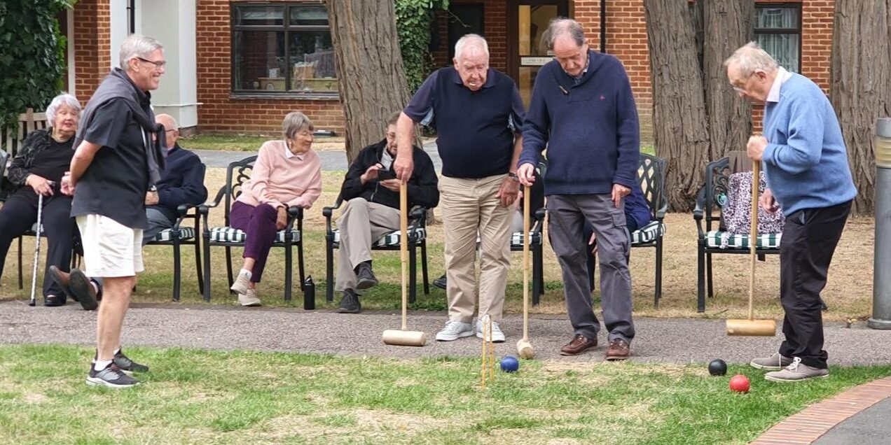 Residents and governors playing croquet