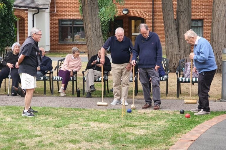 Residents and governors playing croquet